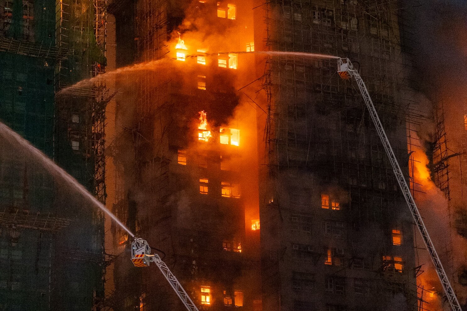 3 arrested in Hong Kong, as a high-rise fire leaves at least 44 dead and 279 reported missing